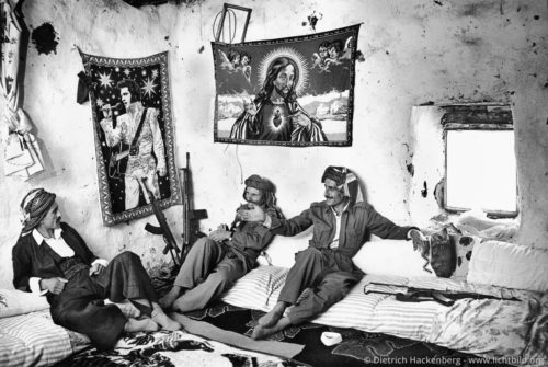 Kurdische Dorfwächter - Beytüssebap, Provinz Hakkari, Türkei 1991 An der Wand Teppiche mit Elvis und Jesus.- Foto © Dietrich Hackenberg