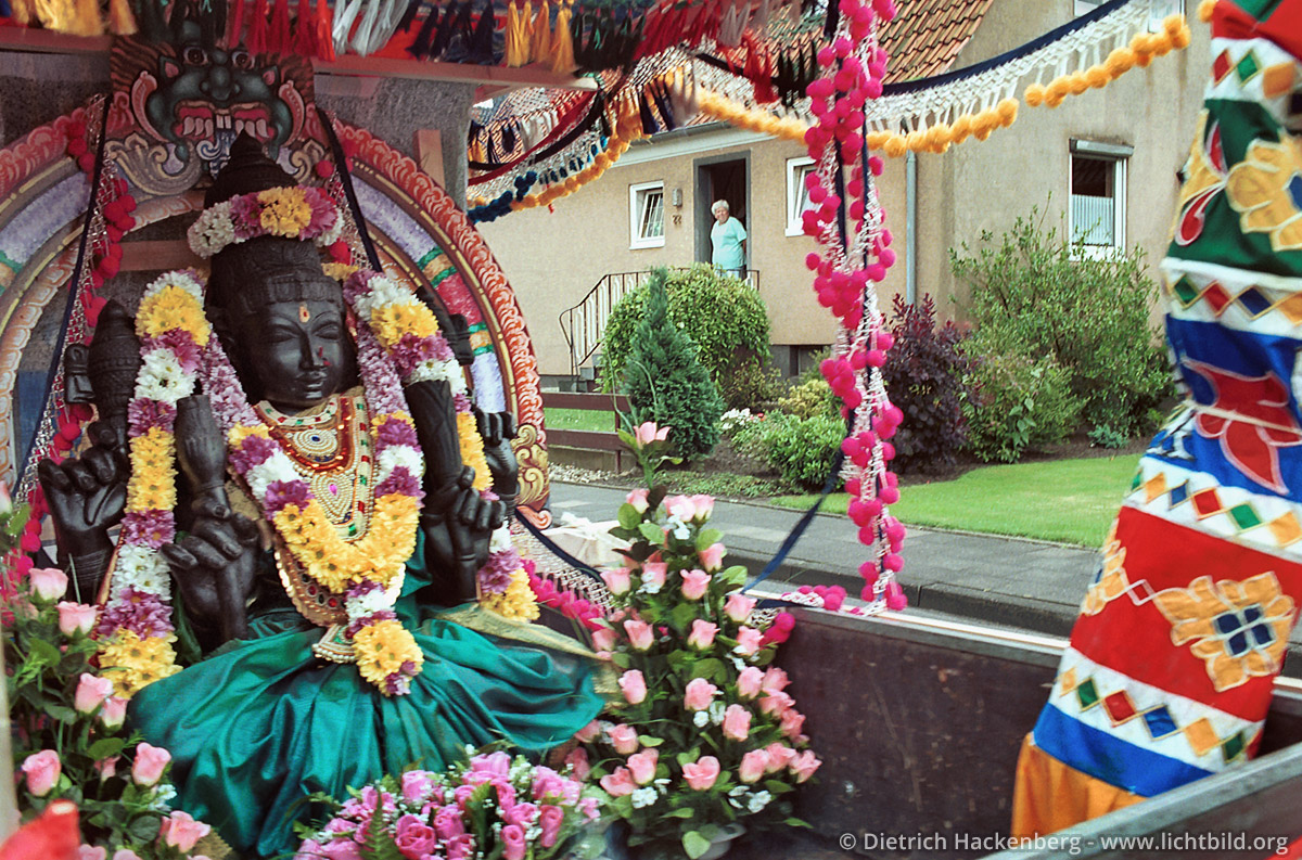Umzug mit Göttin durch ein Wohngebiet - Hindutempel, Hamm-Uentrop -Die Göttin Sri Kamadschi Ampal wird durch die Vororte von Hamm gefahren, bevor sie in den neugebauten Tempel einzieht. Sie soll Menschen und Umgebung kennenlernen. Foto © Dietrich Hackenberg